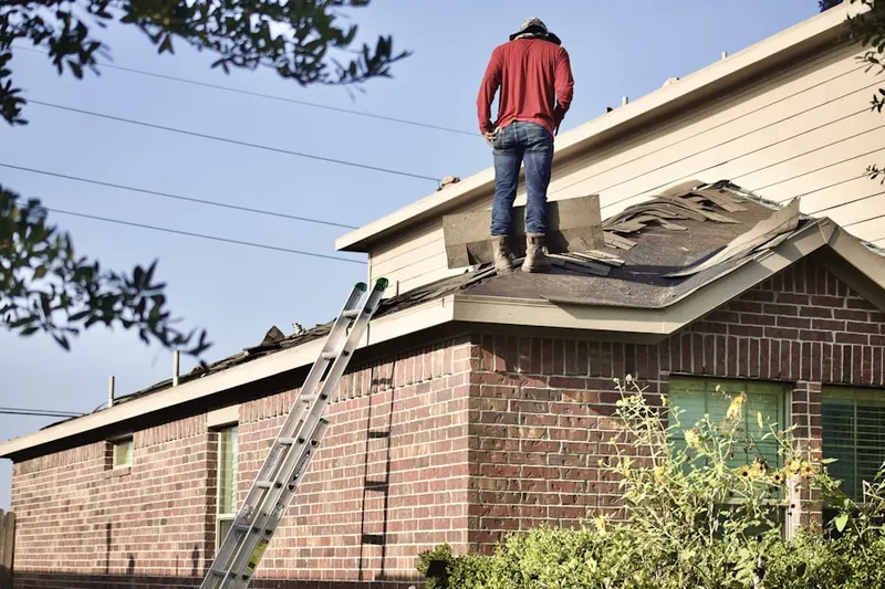 Professional roofer working on a residential roof in Hartford City